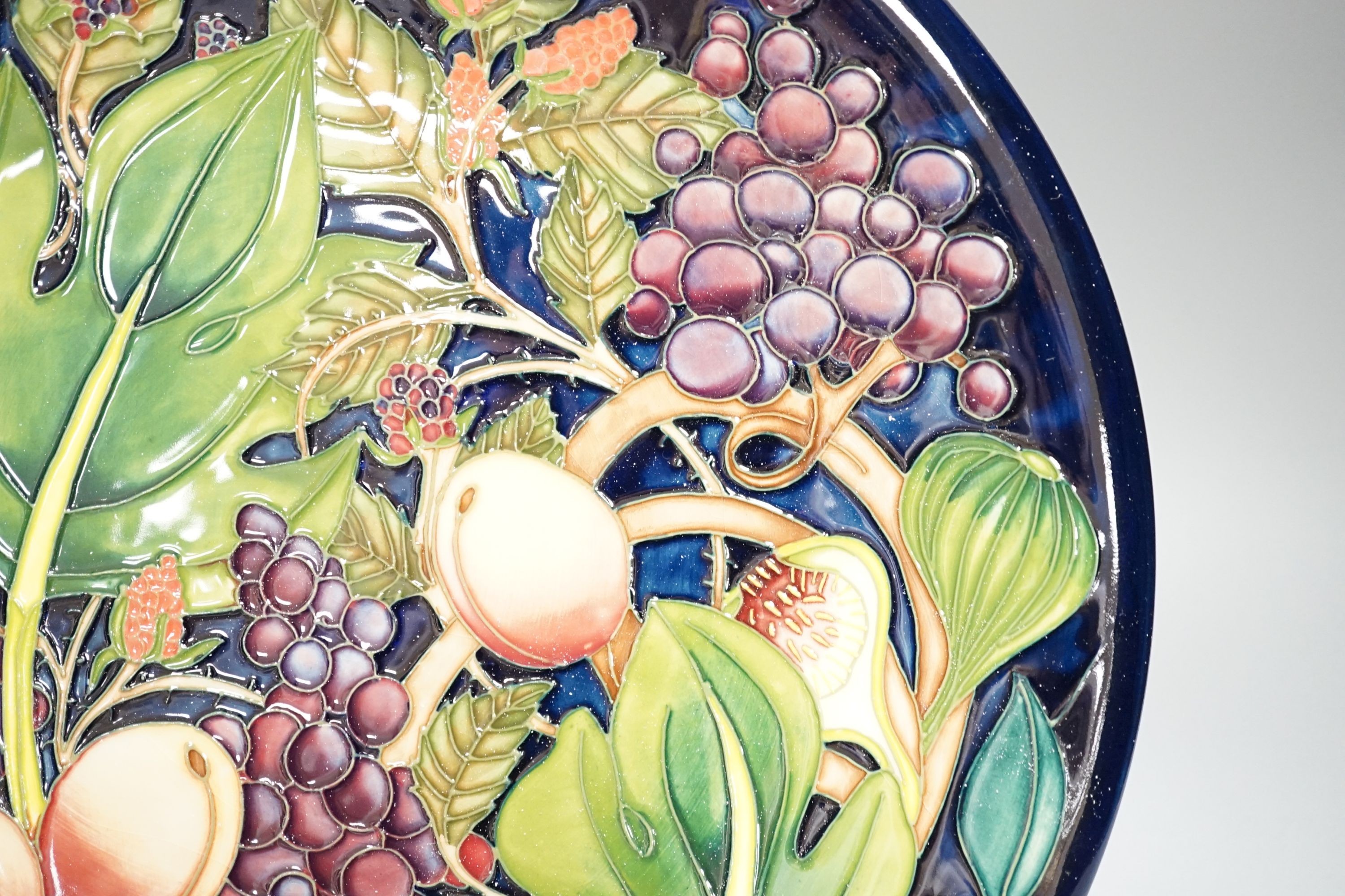 A Moorcroft Queen’s Choice pattern wall charger, dated 2003, signed by Emma Bossons, 36cm., in original box